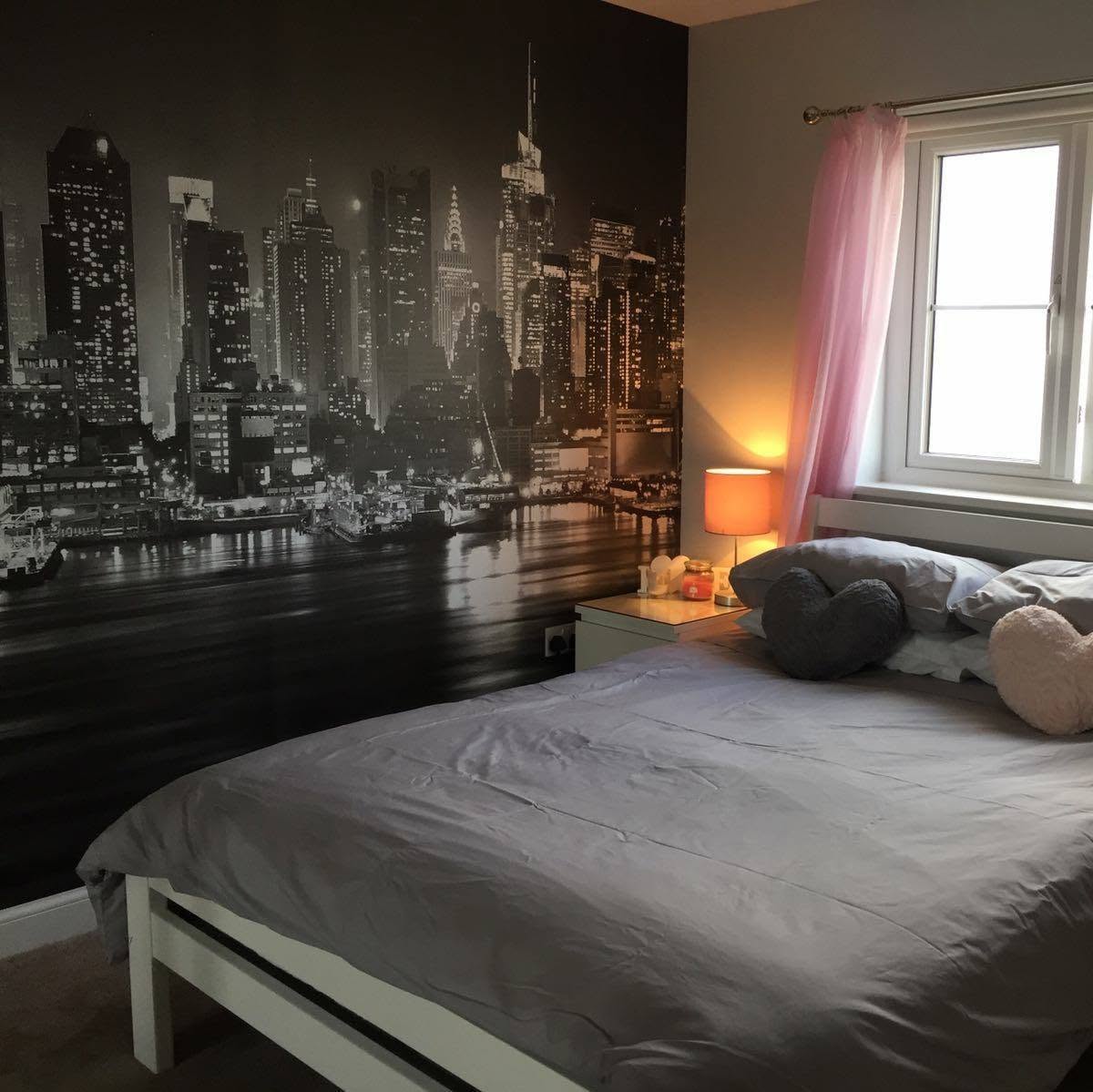 Black and white cityscape wall mural in a bedroom