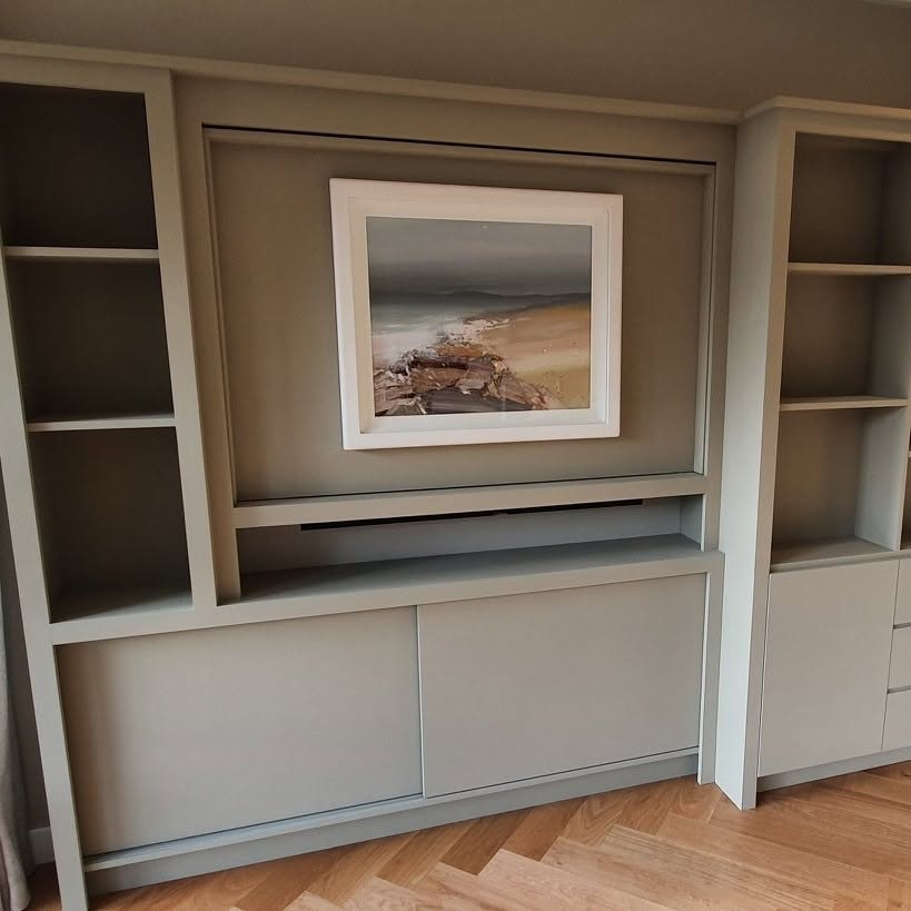 Painted fitted cabinets and shelving with a framed picture